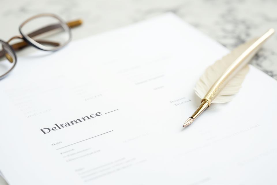 Legal document with a pen and glasses, representing terms and conditions